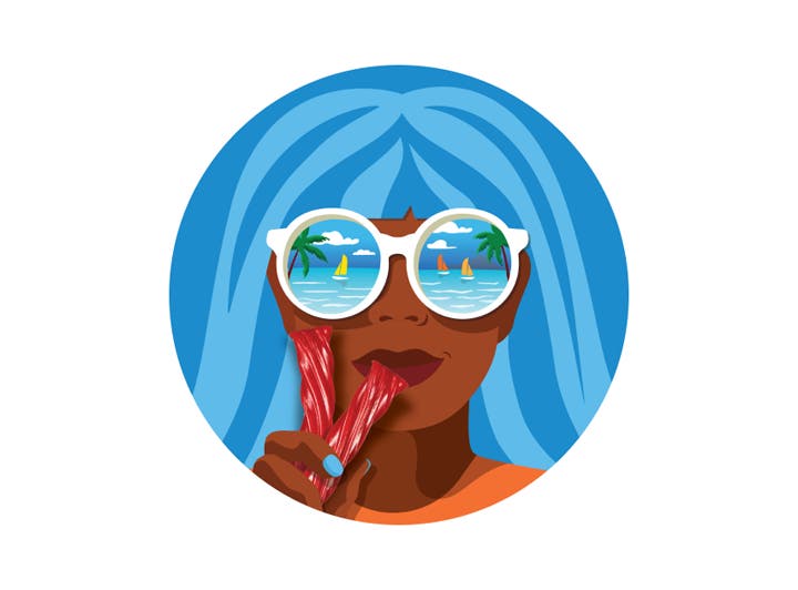 woman eating twizzlers with the ocean being reflected in her sunglasses